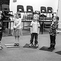 Some young children taking part in a music lesson